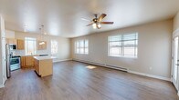 Located at 4615 Trellis Dr in De Pere, Wisconsin, this single-floor residence offers a thoughtfully designed layout with a cohesive blend of functionality and comfort. The open-concept living and kitchen area forms the heart of the space, bathed in natural light from multiple large windows that frame outdoor views of the surrounding neighborhood. Durable wood-look flooring extends throughout the main living areas, while a ceiling fan overhead adds both practicality and a finishing touch to the generous living room.

The kitchen is well-equipped with stainless steel appliances, including a refrigerator, range, and over-the-range microwave. Light wood cabinetry, stone-look countertops, and a classic subway tile backsplash lend the kitchen a clean, modern aesthetic. A central island provides additional prep and gathering space, seamlessly connecting the kitchen to the living area.

The bedrooms feature plush carpeting, ceiling fans, and wall-unit air conditioners, with baseboard heating ensuring year-round comfort. Each room benefits from natural light via well-positioned windows. The bathrooms are finished with wood-look flooring, light wood vanities, stone-look countertops, and a walk-in shower, offering a clean and practical design throughout.