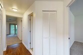Located at 7500 N Newburgh Rd in Westland, Michigan, this two-bedroom, one-bathroom home offers a well-organized single-floor layout with a practical and comfortable design throughout. The combined kitchen and living room serves as the heart of the home, with the kitchen featuring white cabinetry, granite-style countertops, stainless steel appliances, and hardwood-style flooring, all brightened by a large window with outdoor views. The adjacent living room is carpeted and highlighted by a corner fireplace and a sliding glass door that opens to a private balcony overlooking lush greenery, filling the space with natural light. Both bedrooms are carpeted and neutral in tone, offering a calm and versatile environment. The primary bedroom provides a comfortable footprint with ample room for furnishings. A dedicated closet with louvered bi-fold doors is conveniently located in the hallway. The full bathroom includes tile flooring, white cabinetry with granite-style countertops, and a louvered closet for additional storage. A staircase is also present within the unit. Clean white walls and consistent finishes throughout contribute to a bright, cohesive ambiance across the entire home.