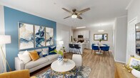 This ground-floor, two-bedroom, two-bathroom unit in Mobile, Alabama, offers a well-designed, single-level layout with a cohesive contemporary aesthetic. Crown molding and wood-look flooring extend throughout, lending a polished continuity to each space.

The open-concept living area serves as the heart of the unit, featuring a bold blue accent wall, ceiling fan, and large windows that invite natural light. The space flows seamlessly into a defined dining area, highlighted by a drum pendant light, chair rail molding, and room for a four-seat table.

The kitchen is outfitted with white shaker cabinetry, light quartz countertops, a subway tile backsplash, and stainless steel appliances, including a range, microwave, and refrigerator. A breakfast bar provides additional seating and connects the kitchen to the main living area.

Both bedrooms are comfortably sized, featuring windows with natural light and closet storage. Each is served by its own full bathroom. One bathroom includes a white vanity with a large mirror and a tub-shower combination, while the second bathroom also features a tub-shower and access to an adjoining walk-in closet area, offering practical storage solutions throughout the unit.