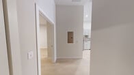 Located at 601 Wood St in the heart of Pittsburgh, PA, this thoughtfully designed one-bedroom, one-bathroom residence offers a clean, modern aesthetic throughout its well-utilized single floor. Light wood flooring runs continuously across all rooms, lending a bright and cohesive feel to the entire space.

The kitchen is a standout feature, outfitted with shaker-style gray cabinetry extending to the ceiling for ample storage, white quartz countertops, a herringbone tile backsplash, and a full suite of stainless steel appliances including a refrigerator, range, built-in microwave, and dishwasher.

The spacious bedroom offers generous proportions, filled with natural light from large floor-to-ceiling windows that frame views of the surrounding cityscape. Two closets provide abundant storage, including a walk-in closet with built-in wire shelving systems.

The bathroom is elegantly finished with marble-look tile flooring, a wide vanity with white countertops, gray shaker cabinetry, and a large backlit mirror that enhances the bright, clean atmosphere.

Neutral warm-gray walls throughout complement the light flooring, creating an inviting and versatile canvas. The open hallway connects all rooms efficiently, contributing to the smooth, functional flow of this well-designed urban residence.