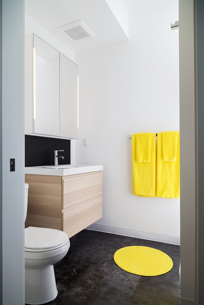 bathroom features lots of storage, vanity with large drawers, mirrored medicine cabinet cabinet with integrated lighting, and laundry (not pictured) - 636 North Prospect Street