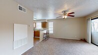 This single-floor, 1-bedroom, 1-bathroom unit offers a practical and comfortable layout designed to maximize every square foot. The open living area is finished with plush wall-to-wall carpeting and features a ceiling fan with integrated lighting, a textured ceiling, and a built-in HVAC unit, creating a cozy and climate-controlled environment. Natural light filters in through multiple windows, keeping the space bright and welcoming.

The kitchen flows seamlessly from the living area and is equipped with warm wood-toned cabinetry, a full suite of white appliances including a refrigerator and electric range, and durable laminate wood flooring. A peninsula counter with bar seating provides a casual dining option and defines the boundary between the kitchen and living space.

The bedroom is a generously sized retreat, also carpeted, with a ceiling fan, a large window for natural light, and two mirrored sliding-door closets offering abundant storage. Direct access to the bathroom is conveniently located off the bedroom.

The bathroom features wood-look flooring, a wood-toned vanity with countertop storage, and a full-size soaking tub and shower combination with clean white tile surround. Throughout the unit, neutral tones and consistent finishes create a cohesive, move-in-ready atmosphere.