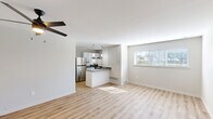Located in Royal Oak, MI, this efficiently designed single-floor unit offers a thoughtfully laid-out open-concept living and kitchen space. Light-toned wood plank flooring runs throughout, lending warmth and visual continuity across the entire unit. The living area is bright and airy, benefiting from natural light streaming through horizontal-blind-fitted windows, and features a ceiling fan with integrated lighting. Crisp white walls and clean baseboards complete the fresh, modern aesthetic.

The kitchen is positioned as a natural focal point, anchored by a peninsula with a gray quartz-style countertop and an undermount sink with a brushed nickel faucet. White shaker-style cabinetry provides ample storage, while stainless steel appliances — including a full-size refrigerator and electric range — add a sleek, contemporary touch. Pendant lighting above the peninsula enhances both function and style.

The bathroom showcases classic white subway tile in the shower/tub surround, finished with dark grout that creates a striking, timeless contrast. The overall design of the unit emphasizes clean lines, neutral tones, and modern updates, making efficient use of every square foot. The unit's location in Royal Oak places it within reach of a vibrant community known for its walkable neighborhoods and diverse amenities.