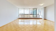 Located at 299 Glenlake Ave in Toronto's vibrant west end, this well-appointed 3-bedroom, 2-bathroom unit offers a thoughtfully organized single-floor layout. The open living area immediately impresses with its gleaming parquet flooring and expansive floor-to-ceiling windows that flood the space with natural light and provide sweeping outdoor views of the surrounding cityscape, including access to a balcony. The neutral, light grey walls throughout lend a clean and versatile aesthetic.

The kitchen is efficiently designed with white cabinetry, tile flooring, a full-size refrigerator, and generous counter space. The three bedrooms are comfortably proportioned, with the generously sized primary bedroom offering parquet floors and large windows. The additional bedrooms also feature the same warm parquet flooring and ample natural light. A dedicated closet provides practical storage.

The two bathrooms are clean and functional: one features a full soaker tub with white tile surround and chrome fixtures, while the second includes a vanity with a wall mirror. Connecting hallways and a dedicated closet space with built-in shelving add to the unit's practicality. Overall, the space presents a bright, neutral, and livable environment well-suited to a variety of lifestyles.