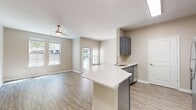 This contemporary 600 sq ft apartment in Towson, MD offers a blend of style and functionality. The open concept living area seamlessly integrates the kitchen and living room, creating a spacious feel. The kitchen boasts sleek gray cabinetry, stainless steel appliances, and a convenient breakfast bar, perfect for casual dining or entertaining.

The generously sized 140 sq ft bedroom features a walk-in closet and large windows that flood the space with natural light. The bathroom is well-appointed with a modern vanity and a shower/tub combination. Wood-look flooring runs throughout the apartment, providing a cohesive and elegant appearance.

Large windows in every room offer ample natural light and views of the surrounding greenery. The neutral color palette of beige walls and white trim creates a canvas for personal style. Additional features include recessed lighting, a private balcony or patio, and in-unit laundry facilities.

Located at 960 Southerly Rd, this apartment offers the perfect balance of suburban tranquility and urban convenience in the heart of Towson.
