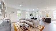 Located in Alameda, CA (94501), this thoughtfully designed single-floor residence blends modern aesthetics with functional living. The open-concept living and dining area is bathed in natural light from multiple large windows that frame lush outdoor greenery, all set atop durable wood-look flooring. Recessed lighting and clean white walls create a bright, airy atmosphere throughout.

The kitchen is outfitted with stainless steel appliances, including a refrigerator, range, and over-the-range microwave. Sleek gray wood cabinetry pairs with white quartz countertops and a textured tile backsplash, delivering a polished, contemporary finish.

The primary bedroom features a generous picture window with scenic views, ample natural light, and access to a well-appointed en-suite bathroom. The en-suite boasts a dual-sink vanity with white quartz countertops, gray cabinetry, and wood-look tile flooring. A second bedroom offers a walk-in closet and its own access to a full bathroom complete with a soaking tub and subway tile surround.

Throughout the residence, a cohesive design language ties each space together — from the hardwood-style floors to the crisp white walls — creating a calm, contemporary ambiance ideal for modern living.