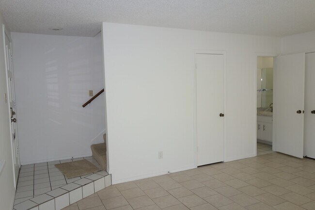 Living room facing South. Entry and stairs on the left. Closet in middle and half bath on right - 3451 E 35th St