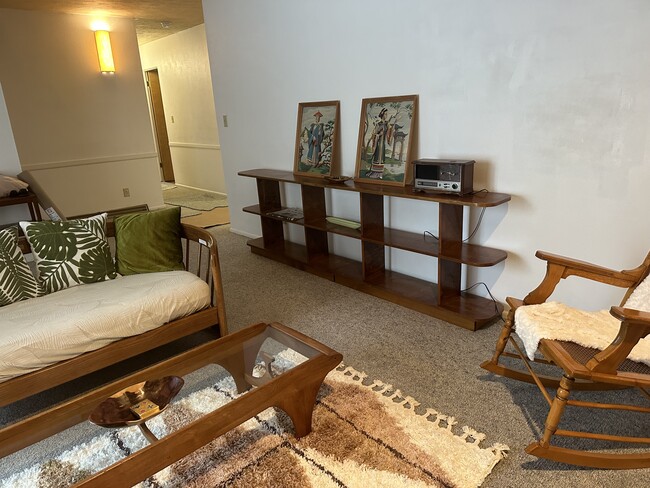 Main floor living room with view of hallway that leads to 3 main floor bedrooms. - 1214 Lincolnwood Rd