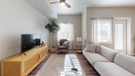 This single-story residence offers a thoughtfully designed layout that balances comfort and functionality across its living spaces. The open-concept living and dining area serves as the heart of the home, featuring warm hardwood-style flooring, neutral wall tones, and multiple windows dressed with sheer curtains and blinds that invite an abundance of natural light. Ceiling fans contribute to the airy ambiance, while the seamless flow between the living and dining zones makes the space feel expansive and welcoming.

The kitchen is a standout feature, equipped with stainless steel appliances including a gas range and dishwasher, complemented by light wood-grain cabinetry, white quartz-style countertops, and a tile backsplash. A curved breakfast bar with seating provides a casual dining option and connects effortlessly to the main living area.

The bedrooms are carpeted for comfort and each includes a ceiling fan, ample closet space, and windows with blinds and curtains for privacy and light control.

The bathrooms are finished with wood-grain cabinetry, white countertops, mosaic tile backsplashes, and tub-shower combinations, presenting a clean and contemporary aesthetic throughout.