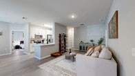 Located at 8801 Citrus Village Dr in Tampa, FL, this single-floor, 2-bedroom, 3-bathroom home offers a thoughtfully designed layout with modern finishes throughout. The open living area features light wood-look flooring, neutral gray walls, and a seamless flow into a second flexible living space — ideal for use as a home office or den — with large windows that invite abundant natural light and views of the surrounding greenery. The galley-style kitchen is well-appointed with white shaker cabinets, quartz countertops, a subway tile backsplash, stainless steel appliances, and a deep single-basin sink, with a direct sightline to the dedicated in-unit laundry closet housing a full-size washer and dryer. The spacious primary bedroom includes a ceiling fan, generous closet access, and windows with blinds for privacy. The second bedroom is equally comfortable, also featuring natural light and closet space. All three bathrooms maintain a clean, contemporary aesthetic with white vanities, wood-look tile flooring, and one full bath featuring a shower-tub combination. Two dedicated closets provide ample storage, completing this efficient and well-appointed home in the Citrus Village community of Tampa.