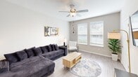 Located at 2775 Red Apple Circle in Kissimmee, FL, this 2-bedroom, 3-bathroom single-floor residence offers a thoughtfully organized layout ideal for comfortable living. The open living room features light wood-style flooring, a ceiling fan, and large windows that fill the space with natural light, creating a bright and welcoming atmosphere. The kitchen is outfitted with crisp white shaker cabinets, granite-style countertops, stainless steel appliances including a refrigerator, range, microwave, and dishwasher, and light wood-look flooring that ties the space together seamlessly. The primary bedroom is a serene retreat with carpeted flooring, natural light from side windows, and a ceiling fan. The second bedroom features dual beds, carpeted flooring, a ceiling fan, and windows overlooking greenery. Each of the three bathrooms is well-appointed with white vanity cabinetry, granite-style countertops, and shower-tub combinations featuring clean white subway tile surrounds and wood-look vinyl flooring. A dedicated closet provides additional storage. The residence also includes a dedicated laundry area visible from the secondary bedroom. The overall aesthetic is clean, modern, and neutral throughout.
