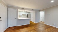 Located at 549 Southwinds Drive in Franklin, TN, this one-bedroom, two-bathroom unit offers a well-planned single-floor layout that maximizes every square foot. Rich hardwood flooring flows throughout the main living areas, creating a warm and cohesive feel from the living room to the kitchen.

The open-concept living room is bright and airy, featuring crown molding, a textured ceiling, and a glass-paned exterior door that invites natural light. The kitchen is efficiently designed with white shaker-style cabinetry, a subway tile backsplash, white countertops, and a full suite of stainless steel appliances including a refrigerator, range, microwave, and dishwasher. A peninsula counter provides additional prep space and a natural divide between the kitchen and living area.

The bedroom offers a comfortable, well-proportioned space finished with plush carpeting, a ceiling fan, and a window for natural light. A walk-in closet provides ample storage. Two full bathrooms serve the unit, one featuring an extended white vanity with generous counter space and hardwood flooring. A dedicated laundry area with full-size washer and dryer hookups adds everyday convenience. The hallway connects all spaces cleanly, completing this practical and well-appointed home.