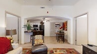 This thoughtfully designed single-floor residence offers 1 bedroom, 2 bathrooms, and a versatile layout that maximizes every square foot. The living room greets you with soaring vaulted ceilings, a front entry door flanked by sidelights that invite natural light, and durable tile and carpet flooring throughout. A dramatic arched passageway connects the living area to the open-concept kitchen and dining spaces, creating a seamless flow ideal for everyday living and entertaining.

The kitchen is well-equipped with ample white cabinetry, dark granite-style countertops, black appliances including a dishwasher and range, and a pass-through window that maintains visual connectivity to the living area. Adjacent to the kitchen, a dedicated dining area provides comfortable space for meals, and a conveniently located in-unit washer and dryer closet adds practical functionality.

The bedroom offers a carpeted, cozy retreat with natural light from window blinds. A dedicated office with carpeted floors and a window provides a quiet workspace. Both bathrooms feature tile flooring and vanity storage; one includes a tub/shower combination with a sliding glass enclosure. The overall ambiance is warm and neutral, with a clean, open feel throughout.