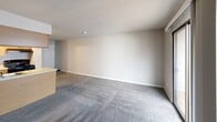 This 540 square foot apartment in Wichita, Kansas offers a well-designed living space with a thoughtful layout. The single-floor unit comprises one bedroom, one bathroom, and an open-concept kitchen and living area. The bedroom, measuring 120 square feet, features ample closet space with sliding doors and plush carpeting for comfort. The kitchen boasts wood cabinetry, a breakfast bar, and modern appliances, including a refrigerator and stove. The living area seamlessly connects to the kitchen, creating a spacious feel despite the compact footprint. A standout feature is the balcony access via sliding glass doors, bringing natural light into the space and offering outdoor views. The bathroom is equipped with a full-sized bathtub and shower combination. Throughout the apartment, neutral tones and carpeted floors create a cohesive, inviting atmosphere. The textured ceiling and recessed lighting add character to this efficient living space.