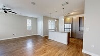 This contemporary residence in Las Vegas offers 1,340 square feet of thoughtfully designed living space spread across two floors. The home boasts four bedrooms and three bathrooms, providing ample space for family living or hosting guests. The primary bedroom, measuring 150 square feet, offers a spacious retreat.

The interior is characterized by a bright and airy ambiance, with large windows allowing natural light to flood the rooms. The color palette is neutral, featuring light gray walls that create a calm and versatile backdrop. Hardwood flooring runs throughout the main living areas, while plush carpeting adds comfort to the bedrooms.

The kitchen is a highlight, showcasing modern design with sleek wooden cabinetry, granite countertops, and high-end stainless steel appliances. A central island with a sink provides additional prep space and casual seating. Pendant lighting adds a touch of elegance to the space.

Bathrooms are well-appointed with contemporary fixtures, including white porcelain sinks and toilets. Some bathrooms feature shower-tub combinations, while others have standalone showers. The use of wood-look flooring in the bathrooms adds warmth to these spaces.

Additional features include ceiling fans for improved air circulation and window blinds for privacy and light control. The home's layout is open and flowing, with a seamless transition between the kitchen, dining, and living areas, making it ideal for modern living and entertaining.