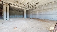 Located at 850 S Gadsden Street in Tallahassee, Florida, this single-floor commercial shell space presents a rare opportunity for a fully customized buildout. The open-plan layout offers a generous, column-punctuated footprint that provides flexibility for a wide range of commercial uses. The structure is built with a robust concrete framework, featuring exposed concrete walls, structural columns, and a flat ceiling with visible overhead mechanical, electrical, and plumbing rough-ins already in place — giving future tenants a head start on buildout planning. Insulated stud walls are partially installed along portions of the perimeter, indicating active construction progress. Large floor-to-ceiling storefront glazing and double-door entry points flood the space with abundant natural light and provide clear sightlines to the surrounding streetscape. The ceiling height is notably generous, lending the space a strong sense of volume and openness. Multiple access points, including a utility door, are visible throughout. The unfinished concrete floor is ready for the tenant's choice of flooring. Situated in a well-connected Tallahassee corridor, this shell space is an ideal candidate for retail, restaurant, office, or other commercial uses seeking a modern, light-filled environment with a strong structural foundation.