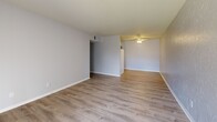 Located at 950 Buena Vista St in Amarillo, Texas, this single-floor, two-bedroom, one-bathroom unit offers a well-organized layout across a comfortably sized floor plan. The living room features light wood-look vinyl flooring, a textured accent wall, and a sliding glass door with vertical blinds that opens to an outdoor patio, allowing natural light to fill the space. Adjacent areas continue the wood-look flooring, maintaining a cohesive, clean aesthetic throughout the common spaces. The primary bedroom is generously proportioned, featuring soft carpeting, a ceiling fan, and a walk-in closet equipped with dual hanging rods on both sides — providing ample storage. The second bedroom also features carpet flooring, a ceiling fan, and a window with blinds that brings in natural light. Both bedrooms are finished in neutral tones, offering a versatile backdrop. The bathroom includes a full soaking tub with white tile surround, wood-look flooring, and a vanity with dark cabinetry. A dedicated closet adds additional storage to the unit. The overall design is practical and neutral, with consistent finishes throughout that create a clean, move-in-ready environment.