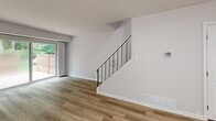 This well-appointed two-story home in Horsham, PA offers a thoughtfully designed layout spread across two floors. The main level features a bright, open living room with warm hardwood-style flooring, a sleek staircase with an elegant iron railing, and a sliding glass door that floods the space with natural light while providing access to a private patio surrounded by mature trees. The kitchen is outfitted with white shaker cabinetry, stainless steel appliances, a gas range, a built-in dishwasher, and striking marble-look tile flooring, complemented by a window overlooking the outdoors. A dining area and a utility room round out the lower level. Upstairs, two carpeted bedrooms offer comfortable retreats, each with ample closet space. The generously sized primary bedroom features a wide window for natural light and a spacious closet. The second bedroom connects conveniently to the upper hallway with built-in shelving. Both bathrooms are finished with clean white fixtures, and one features elegant marble-look tile surrounding a soaking tub. With four closets, two hallways, and a clean, neutral palette throughout, this home delivers a move-in ready environment with modern, functional appeal.