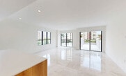 This contemporary condo in Coral Gables offers 1,570 square feet of elegant living space. The unit features three bedrooms, including a spacious 240 sq ft primary suite, and three full bathrooms. The open-concept design seamlessly integrates the kitchen and living areas, creating an ideal space for both relaxation and entertaining.

The gourmet kitchen boasts sleek cabinetry combining white upper cabinets with warm wood lower cabinets and a matching island. High-end appliances and ample counter space make it perfect for culinary enthusiasts. Throughout the home, gleaming tile floors and recessed lighting contribute to the modern aesthetic.

Large windows in the bedrooms and living areas flood the space with natural light while offering picturesque city and green space views. The unit also includes a private balcony, featuring architectural arches and planters, providing an outdoor retreat with urban vistas.

Each bathroom is designed with contemporary fixtures and finishes, including a stylish bathtub in at least one of the bathrooms. The condo's neutral color palette creates a blank canvas for personalization while maintaining a sophisticated ambiance.

Located at 701 Valencia in Coral Gables, this third-floor unit (302) combines the charm of its surroundings with the convenience of urban living. With its thoughtful design and prime location, this condo offers a luxurious lifestyle in one of Miami's most desirable neighborhoods.