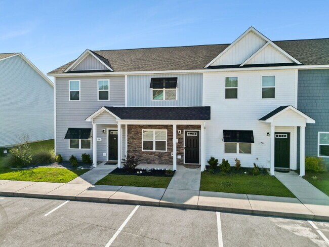 Building Photo - Available Now! Enjoy low-maintenance coastal living in this beautiful 2-bedroom, 2.5-bath townhom...