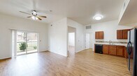 Located at 715 Monnett Ave in Norman, Oklahoma, this single-story 4-bedroom, 3-bathroom home offers a well-organized and functional layout. Warm wood-look flooring flows consistently throughout the home, creating a cohesive and inviting atmosphere.

The combined kitchen and living area serves as the heart of the home. The kitchen is equipped with rich medium-toned cabinetry, a decorative mosaic tile backsplash, light countertops, and a full suite of black appliances including a range, microwave, dishwasher, and refrigerator. The adjacent living room features vaulted ceilings, a ceiling fan, and sliding glass doors that open to a private balcony with views of lush greenery — filling the space with natural light and outdoor connectivity.

The four bedrooms are comfortably sized, each with ceiling fans and windows that bring in natural light and neighborhood views. The primary bedroom provides a quiet retreat with generous proportions.

The three bathrooms are finished with warm diagonal-set stone tile surrounds in the tub/shower areas and coordinating tile flooring, complemented by white vanities with dark hardware. A dedicated laundry room houses a full-size washer and dryer along with the home's mechanical systems. The connecting hallway ties the layout together with a clean, open sightline throughout.
