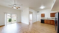 Located at 715 Monnett Ave in Norman, Oklahoma, this single-story 4-bedroom, 3-bathroom home offers a well-organized and functional layout. Warm wood-look flooring flows consistently throughout the home, creating a cohesive and inviting atmosphere.

The combined kitchen and living area serves as the heart of the home. The kitchen is equipped with rich medium-toned cabinetry, a decorative mosaic tile backsplash, light countertops, and a full suite of black appliances including a range, microwave, dishwasher, and refrigerator. The adjacent living room features vaulted ceilings, a ceiling fan, and sliding glass doors that open to a private balcony with views of lush greenery — filling the space with natural light and outdoor connectivity.

The four bedrooms are comfortably sized, each with ceiling fans and windows that bring in natural light and neighborhood views. The primary bedroom provides a quiet retreat with generous proportions.

The three bathrooms are finished with warm diagonal-set stone tile surrounds in the tub/shower areas and coordinating tile flooring, complemented by white vanities with dark hardware. A dedicated laundry room houses a full-size washer and dryer along with the home's mechanical systems. The connecting hallway ties the layout together with a clean, open sightline throughout.