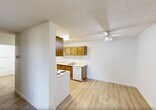Located at 1112 Hermitage Road NW in Edmonton, Alberta, this one-bedroom, one-bathroom unit offers a practical and comfortable single-floor layout. Light wood laminate flooring flows consistently throughout, lending warmth and cohesion to the space.

The combined dining and living area is bright and open, featuring a large sliding glass door that provides access to a balcony and allows natural light to fill the room. A ceiling fan adds comfort, and baseboard heating is present throughout the unit. The textured ceilings are consistent across the living spaces.

The galley-style kitchen is efficiently designed with warm wood cabinetry on both upper and lower sections, white appliances including a coil-top stove, refrigerator, and dishwasher, as well as a single-basin sink with ample counter space.

The spacious primary bedroom features a window overlooking greenery, baseboard heating, and a generously sized closet with sliding panel doors and a hanging rod. Additional storage is well-served by four closets throughout the unit, including a hallway closet with open shelving behind a bi-fold door.

The bathroom includes a full tub and shower combination with white tile surround and a safety grab bar. A central hallway connects all rooms, contributing to an efficient and functional flow throughout the unit.