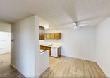 Located at 1112 Hermitage Road NW in Edmonton, Alberta, this one-bedroom, one-bathroom unit offers a practical and comfortable single-floor layout. Light wood laminate flooring flows consistently throughout, lending warmth and cohesion to the space.

The combined dining and living area is bright and open, featuring a large sliding glass door that provides access to a balcony and allows natural light to fill the room. A ceiling fan adds comfort, and baseboard heating is present throughout the unit. The textured ceilings are consistent across the living spaces.

The galley-style kitchen is efficiently designed with warm wood cabinetry on both upper and lower sections, white appliances including a coil-top stove, refrigerator, and dishwasher, as well as a single-basin sink with ample counter space.

The spacious primary bedroom features a window overlooking greenery, baseboard heating, and a generously sized closet with sliding panel doors and a hanging rod. Additional storage is well-served by four closets throughout the unit, including a hallway closet with open shelving behind a bi-fold door.

The bathroom includes a full tub and shower combination with white tile surround and a safety grab bar. A central hallway connects all rooms, contributing to an efficient and functional flow throughout the unit.
