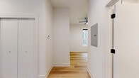 Located in Chicago's vibrant West Loop neighborhood, this well-appointed one-bedroom, one-bathroom unit offers a thoughtfully designed layout with modern finishes throughout. Light hardwood flooring flows continuously across the entire single-floor plan, complementing the clean, neutral color palette and creating a cohesive, airy feel.

The open-concept kitchen and living area serves as the heart of the unit. The kitchen is outfitted with wood-toned cabinetry featuring matte black hardware, white quartz countertops, a full suite of stainless steel appliances including a gas range, dishwasher, built-in microwave, and full-size refrigerator. A generous kitchen island with pendant lighting anchors the space and provides additional prep and seating area. Multiple windows flood the kitchen with natural light and offer views of the surrounding neighborhood.

The bedroom is a calm, well-proportioned retreat featuring a ceiling fan, a window for natural light, and a full double-door closet for ample storage. The bathroom continues the modern design language with wood-finish vanity cabinetry, white quartz surfaces, a large mirror, and matte black fixtures throughout. A private balcony with black steel railings offers outdoor space with open city views, rounding out this stylish urban residence.