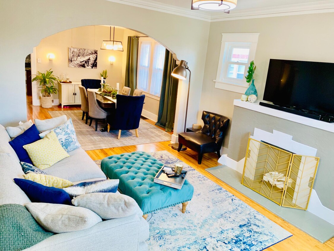 Upstairs living room with large windows, real hardwood floors, decorative fireplace, and full of cra - 1447 Osceola St