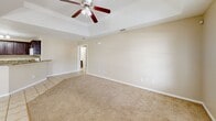Located at 121 E Quamasia Ave in McAllen, TX, this single-story home offers a well-designed layout across three bedrooms and two bathrooms. The interior features a warm, neutral color palette throughout, with light beige walls and clean white trim that create a bright, cohesive atmosphere.

The kitchen is a functional highlight, showcasing rich dark wood cabinetry, granite countertops, tile flooring, and track lighting overhead. It flows naturally into a dedicated dining area, which features light tile flooring and a pendant light fixture, with a window that brings in natural light. The open connection between the kitchen, dining room, and living area supports an easy, everyday flow.

The bedrooms are carpeted and feature tray ceilings with ceiling fans, adding a sense of architectural depth and comfort. The spacious primary bedroom benefits from multiple windows that invite natural light and offer outdoor views. The remaining bedrooms are similarly well-proportioned and bright.

The bathrooms are finished with light tile flooring, dark wood vanity cabinetry, and white countertops. One bathroom includes a shower-tub combination, while both are designed with practicality in mind. Additional closets throughout the home provide ample storage. Overall, the home presents a comfortable and practical living environment suited for everyday use.