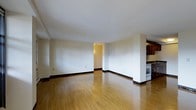 Located at 300 Tresser Blvd in the heart of Stamford, Connecticut, this three-bedroom, one-bathroom residence offers a well-designed single-floor layout with a private balcony. The open-concept living and dining area is bright and airy, featuring warm hardwood flooring that runs throughout, crisp white walls, and clean architectural lines that create an inviting, versatile living space. The kitchen is positioned adjacent to the main living area and is equipped with dark wood cabinetry, built-in appliances including an oven, and ample counter space, making it both functional and efficient. A wide entryway connects the living space to the rest of the home, offering a natural flow between rooms. The three bedrooms provide comfortable accommodations, while the balcony extends the living space outdoors, offering a private retreat for relaxing or entertaining. The overall ambiance of the residence is clean, modern, and move-in ready, with neutral tones and durable finishes throughout. Situated in downtown Stamford, residents benefit from convenient access to local dining, shopping, public transportation, and major commuter routes.
