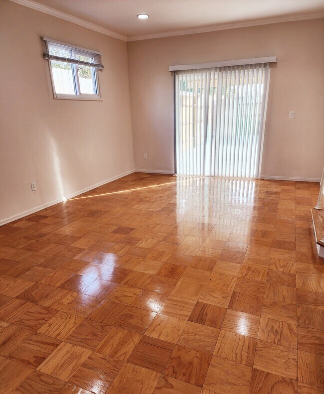 Living Room with resurfaced wood flooring. - 7760 Lurline Ave