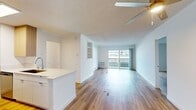 This contemporary 880 square foot apartment in Newport Beach offers a well-designed living space with two bedrooms and two bathrooms. The interior is characterized by its bright, airy atmosphere, enhanced by large windows that flood the rooms with natural light. Hardwood floors run throughout, adding warmth and elegance to the space.

The living area is spacious and open, with a sliding glass door leading to a private balcony that provides city views. Built-in shelving adds functionality and storage. The kitchen is modern and efficient, featuring light wood cabinetry, stainless steel appliances, and a sleek white countertop with an undermount sink.

The primary bedroom is generously sized at 210 square feet, offering ample space for a comfortable retreat. Mirrored closet doors maximize the sense of space while providing storage. The bathrooms are clean and functional, with one featuring a shower/tub combination.

The apartment's neutral color palette and clean lines create a canvas for personal style. With its prime Newport Beach location and thoughtful design, this apartment offers a blend of comfort and contemporary living.