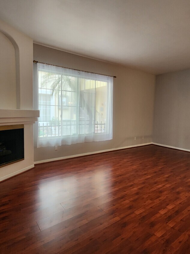 Living room with fireplace and large window - 7037 La Tijera Blvd (Los Angeles, CA)