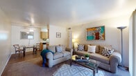 This single-story residence in Marana, Arizona offers a thoughtfully laid-out living space with a warm, welcoming ambiance throughout. The open-concept living and dining area serves as the heart of the home, featuring plush carpeting, neutral tones, and generous natural light. A sliding glass door leads directly to a private patio, offering pleasant outdoor views and seamless indoor-outdoor flow.

The kitchen is efficiently designed with ample oak cabinetry, light countertops, wood-look flooring, and white appliances including a dishwasher, range, and refrigerator. An adjacent dining area provides a comfortable space for everyday meals.

The bedrooms are well-proportioned and restful, each featuring carpeted floors and windows dressed with vertical blinds and curtain panels that allow natural light while maintaining privacy. One bedroom includes a walk-in closet, offering practical storage. The bathroom is cleanly appointed with a single vanity, a full tub-shower combination, and wood-look flooring that ties the space together.

Throughout the residence, wood-look and carpeted flooring create a cohesive aesthetic, while ceiling fans and recessed lighting enhance comfort and functionality. The overall design balances practicality with a comfortable, livable feel suited to the Marana, AZ lifestyle.