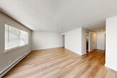 Located at 5900 Soundview Dr in Gig Harbor, WA, this two-bedroom, one-bathroom single-floor unit offers a clean, functional layout with a neutral palette throughout. The spacious living room is a highlight of the home, featuring light wood laminate flooring, a textured ceiling, a baseboard heater, and a full-width sliding glass door with vertical blinds that floods the space with natural light. An additional window provides further brightness and ventilation. The kitchen is efficiently designed with warm wood cabinetry, light countertops, a dishwasher, a range, and a refrigerator, all supported by a window for natural light. Both bedrooms are carpeted for comfort, with textured ceilings and baseboard heating. The primary bedroom offers a generous footprint, while the second bedroom includes a window with views of surrounding greenery. Two closets provide practical storage throughout the unit. The full bathroom features a single-sink vanity with wood cabinetry, a tub/shower combination, and light wood flooring that ties back to the rest of the home. A hallway connects the main living areas to the bedrooms and bathroom, completing this well-organized and move-in-ready floor plan.