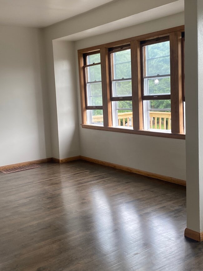 living room, refinished hardwood floors and windows ( original to the home) - 2550 N 45th St