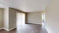 Located at 22700 Civic Center Dr in Southfield, Michigan, this 2-bedroom, 2-bathroom single-floor residence offers a well-organized and functional layout across a comfortable footprint. The living room is bright and open, featuring wood-style plank flooring, neutral taupe walls, white trim, and a sliding glass door dressed with vertical blinds that allows natural light to fill the space. The kitchen is thoughtfully designed with rich, warm-toned wood cabinetry, granite-style countertops, a peninsula with a breakfast bar overhang, a double basin sink, and black appliances including a range and a stainless steel refrigerator. A pass-through window connects the kitchen to the living area, adding an open feel. Both bedrooms are generously proportioned with the same wood-style flooring, neutral walls, and windows with blinds. The primary bedroom is a comfortable size with its own dedicated closet. Each bathroom is clean and functional; one features a walk-in shower stall, while the other includes a vanity with a white countertop and framed mirrors. A dedicated laundry area houses a full-size washer and dryer. Two closets provide ample storage throughout the unit.