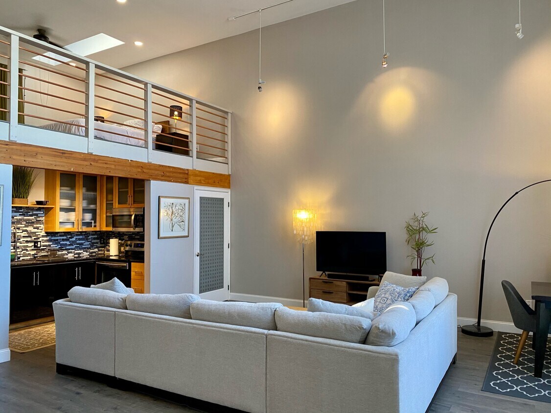 Open and airy living, you’ll love the high, 17ft. tall ceilings with updated light fixtures. - 311 4th St