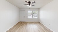 Located at 459 Apartment Court Dr in Baton Rouge, Louisiana, this 2-bedroom, 3-bathroom unit offers a clean, modern aesthetic across a well-organized single-floor layout. Light wood-look flooring runs throughout, complementing the bright white walls and trim that give the space an open, airy feel.

The living room provides a comfortable gathering area, while the galley-style kitchen is efficiently designed with white cabinetry, black hardware accents, white countertops, a natural light-admitting window, and stainless steel appliances including a refrigerator, dishwasher, and range.

Both bedrooms are well-proportioned and feature ceiling fans with light fixtures and windows that bring in natural views of surrounding greenery. The primary bedroom is notably spacious, offering two closets with sliding doors for ample storage. Each room connects smoothly via a central hallway, which also provides access to the bathrooms and additional closet space.

All three bathrooms are finished with large-format marble-look subway tile surrounding soaking tubs and showers, paired with white vanities and wood-look flooring for a cohesive, polished look. The overall design emphasizes clean lines, neutral tones, and functional simplicity throughout.
