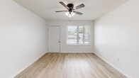 Located at 459 Apartment Court Dr in Baton Rouge, Louisiana, this 2-bedroom, 3-bathroom unit offers a clean, modern aesthetic across a well-organized single-floor layout. Light wood-look flooring runs throughout, complementing the bright white walls and trim that give the space an open, airy feel.

The living room provides a comfortable gathering area, while the galley-style kitchen is efficiently designed with white cabinetry, black hardware accents, white countertops, a natural light-admitting window, and stainless steel appliances including a refrigerator, dishwasher, and range.

Both bedrooms are well-proportioned and feature ceiling fans with light fixtures and windows that bring in natural views of surrounding greenery. The primary bedroom is notably spacious, offering two closets with sliding doors for ample storage. Each room connects smoothly via a central hallway, which also provides access to the bathrooms and additional closet space.

All three bathrooms are finished with large-format marble-look subway tile surrounding soaking tubs and showers, paired with white vanities and wood-look flooring for a cohesive, polished look. The overall design emphasizes clean lines, neutral tones, and functional simplicity throughout.
