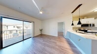 Located at 3140 Saint Rose Pkwy in Henderson, Nevada, this two-story residence offers 2 bedrooms and 4 bathrooms across a well-organized, efficiently designed floor plan. The main living level is anchored by an open-concept kitchen and living area finished with light wood-style flooring throughout. The kitchen is equipped with stainless steel appliances, including a refrigerator, range, microwave, and dishwasher, complemented by white cabinetry, light countertops, and a kitchen island with pendant lighting — creating a clean, contemporary aesthetic. Each bedroom is bright and airy, featuring ceiling fans, large windows that frame outdoor greenery, and easy access to natural light. The primary bedroom includes a private balcony accessible through sliding glass doors. Closets feature wire shelving systems for organized storage. The bathrooms are finished with tile flooring and tub-shower combinations with chrome fixtures. A dedicated in-unit laundry area accommodates a full-size washer and dryer. The hallway connects all rooms seamlessly across the main floor, while a staircase provides access between levels. The overall design is modern and neutral, with white walls, light flooring, and consistent finishes that create a bright, cohesive living environment.