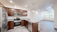 Located at 1503 S Yale St in Flagstaff, Arizona, this well-appointed one-bedroom, one-bathroom unit offers a thoughtfully designed single-floor layout. The kitchen serves as the standout feature of the home, showcasing rich dark-walnut cabinetry, light granite countertops, and a full suite of stainless steel appliances including a refrigerator, range, microwave, and dishwasher. A peninsula with pendant lighting extends the counter space and creates a natural transition into the open living area. Light wood-style flooring runs consistently throughout the unit, lending a clean, cohesive aesthetic. The bedroom is a cozy, private retreat featuring multiple windows dressed with blinds that allow for generous natural light while maintaining privacy. A dedicated closet provides practical storage. The bathroom continues the design language of the kitchen with matching dark cabinetry, granite countertops, and a large vanity mirror framed by overhead lighting. A walk-in closet is conveniently accessible directly from the bathroom. Neutral walls and modern finishes throughout give the space a fresh, move-in-ready feel well-suited for comfortable living in Flagstaff's vibrant community.