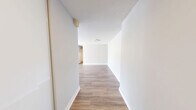 Located at 2645 Battleford Rd in Mississauga, this well-appointed 2-bedroom, 1-bathroom unit offers a clean, modern aesthetic throughout. Light wood laminate flooring flows seamlessly across the entire space, complementing the neutral grey and white wall palette that creates a bright, cohesive feel.

The open-concept kitchen and living area serves as the heart of the unit. The kitchen features white flat-panel cabinetry, a central island with a grey quartz countertop, stainless steel appliances including a French door refrigerator and range, and recessed pot lighting — a fully functional and stylish space for cooking and entertaining.

The living room is a standout, boasting a wall of large floor-to-ceiling windows that flood the space with natural light and offer views of mature trees and greenery, creating a connection to the outdoors.

Both bedrooms are well-proportioned with light-toned flooring, neutral walls, and windows providing natural light and ventilation. The primary bedroom offers a comfortable, private retreat. The bathroom is finished with clean white subway-style tiles, a full soaker tub with an overhead shower, and modern chrome fixtures. The overall ambiance of the unit is fresh, modern, and move-in ready.