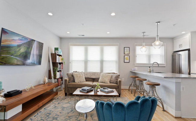 Living room with automatic semi-sheer blinds - 1516 K St SE