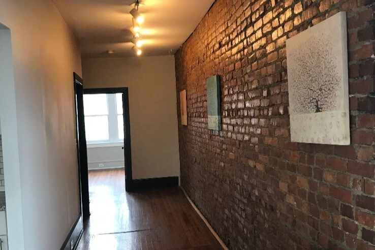 Beautiful exposed brick wall spans the apartm - 688 Haddon Ave