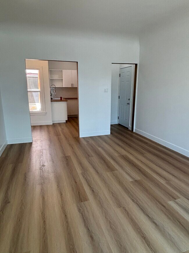 New vinyl flooring throughout living area to kitchen - 2109 1/2 W 54th St