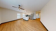 Located at 4591 McRee Ave in St. Louis, MO, this well-appointed 3-bedroom, 2-bathroom home offers a thoughtfully designed single-floor layout with modern finishes throughout. The open-concept living and kitchen area serves as the heart of the home, featuring warm luxury vinyl plank flooring, a ceiling fan, and natural light from large windows with blinds. The kitchen is a standout, boasting white shaker cabinetry with matte black hardware, quartz countertops, a central island, stainless steel appliances, a deep undermount sink, and a striking teal subway tile backsplash — all complemented by pendant lighting. A clean, well-lit hallway connects the living spaces to the private quarters. The primary bedroom is generously sized, with a ceiling fan and a glass-paned door leading to a private balcony overlooking the neighborhood. The additional bedrooms each offer natural light through large windows and consistent vinyl plank flooring. The two bathrooms are finished in a clean, contemporary style — one features a frameless sliding glass shower with white tile and matte black fixtures, while the second includes a white vanity, quartz countertop, and coordinating black hardware. A dedicated closet provides additional storage, completing this cohesive and modern living space.
