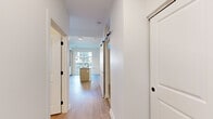 Located at 440 N Monroe St in Tallahassee, FL, this thoughtfully designed one-bedroom, one-bathroom residence offers a modern and efficient layout across a single floor. The open-concept living and kitchen area serves as the heart of the unit, anchored by a sleek center island with a built-in sink and pendant lighting above. Light wood cabinetry, white subway tile backsplash, and a full suite of stainless steel appliances — including a refrigerator, range, and microwave — give the kitchen a clean, contemporary aesthetic. Light-toned hardwood-style flooring flows throughout the main living area, enhancing the bright and airy atmosphere. A sliding glass door connects the living space to a private outdoor balcony, filling the room with natural light. A stylish barn-style door adds a modern design accent within the unit. The bedroom features plush carpeting and a dedicated closet with built-in shelving for organized storage. The bathroom is finished with a light wood vanity, matte black hardware, a framed mirror, and wood-look flooring that ties in with the rest of the home. An in-unit stacked washer and dryer adds everyday convenience. The overall design is clean, neutral, and move-in ready.